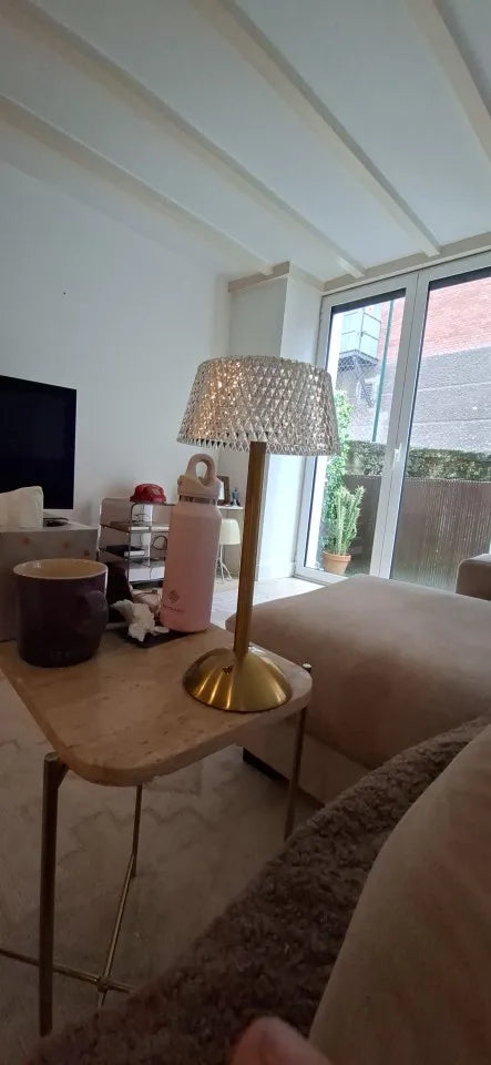 The dome lamp on a side table in a bright living room, by day