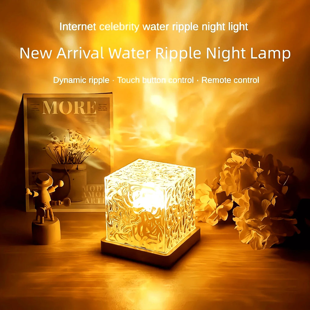 The ripple cube glowing amber on a shelf next to dried flowers