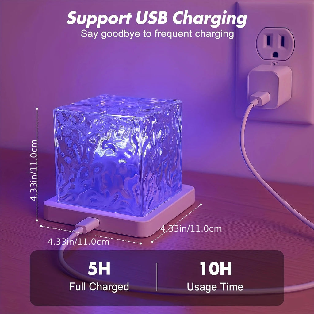 The cube plugged in to charge, 11 cm on each side, marked 5 h charge and 10 h use