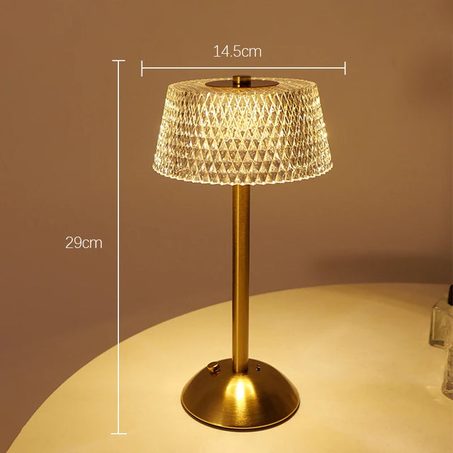 Cordless glass dome lamp lit warm on a round table, gold stem, height 29 cm and shade 14.5 cm marked